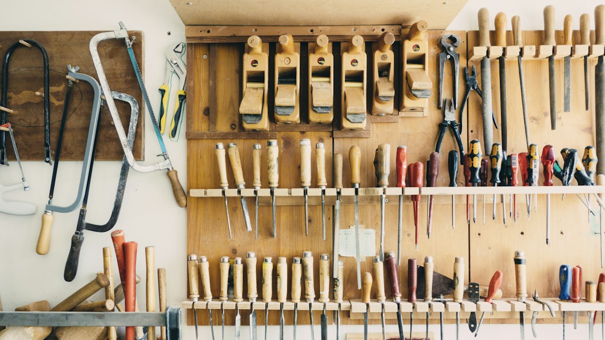 assorted handheld tools in tool rack